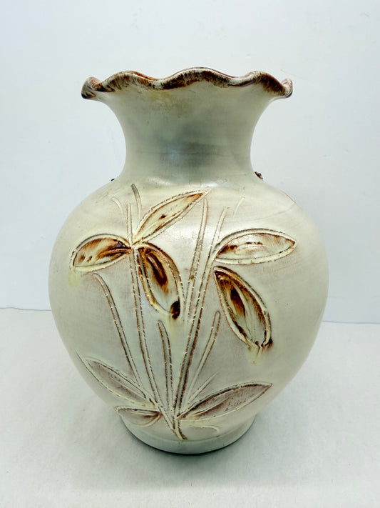 Glazed studio pottery vase with leaves